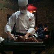 Waiter carves Peking duck at Duck De Chine